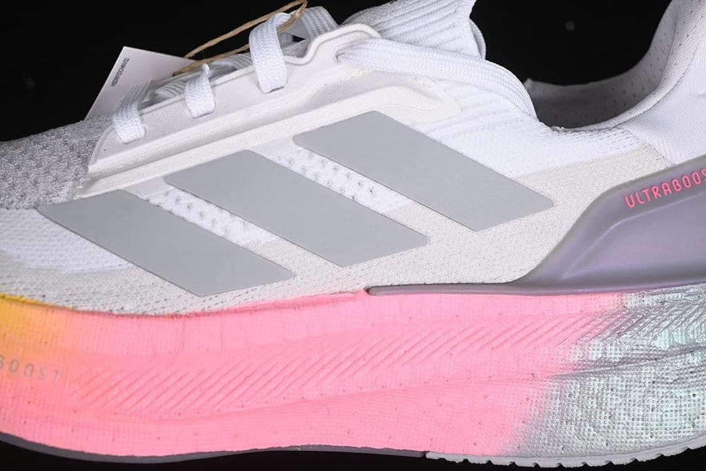 Close-up of grey side stripes and pink midsole accent