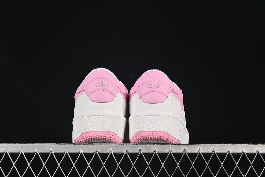 Rear view of both sneakers with pink heel panels