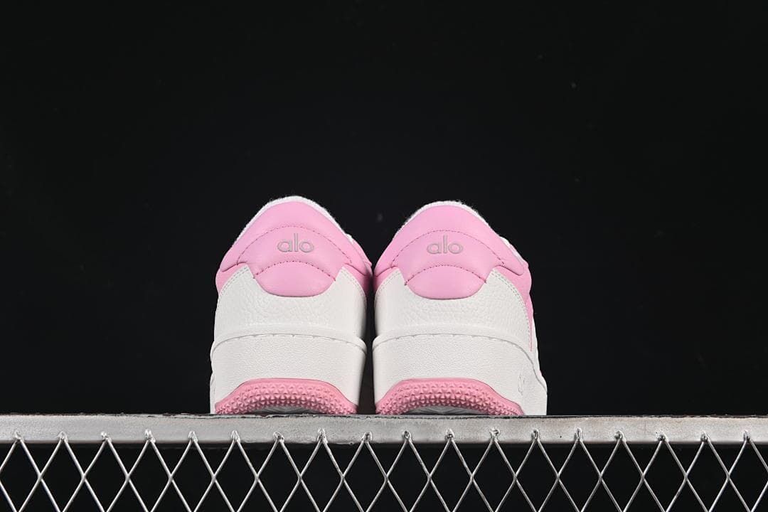 Rear view of both sneakers with pink heel panels