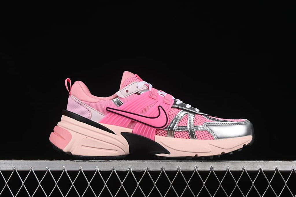 Side profile of a pink Nike V2K Run sneaker with silver-look overlays