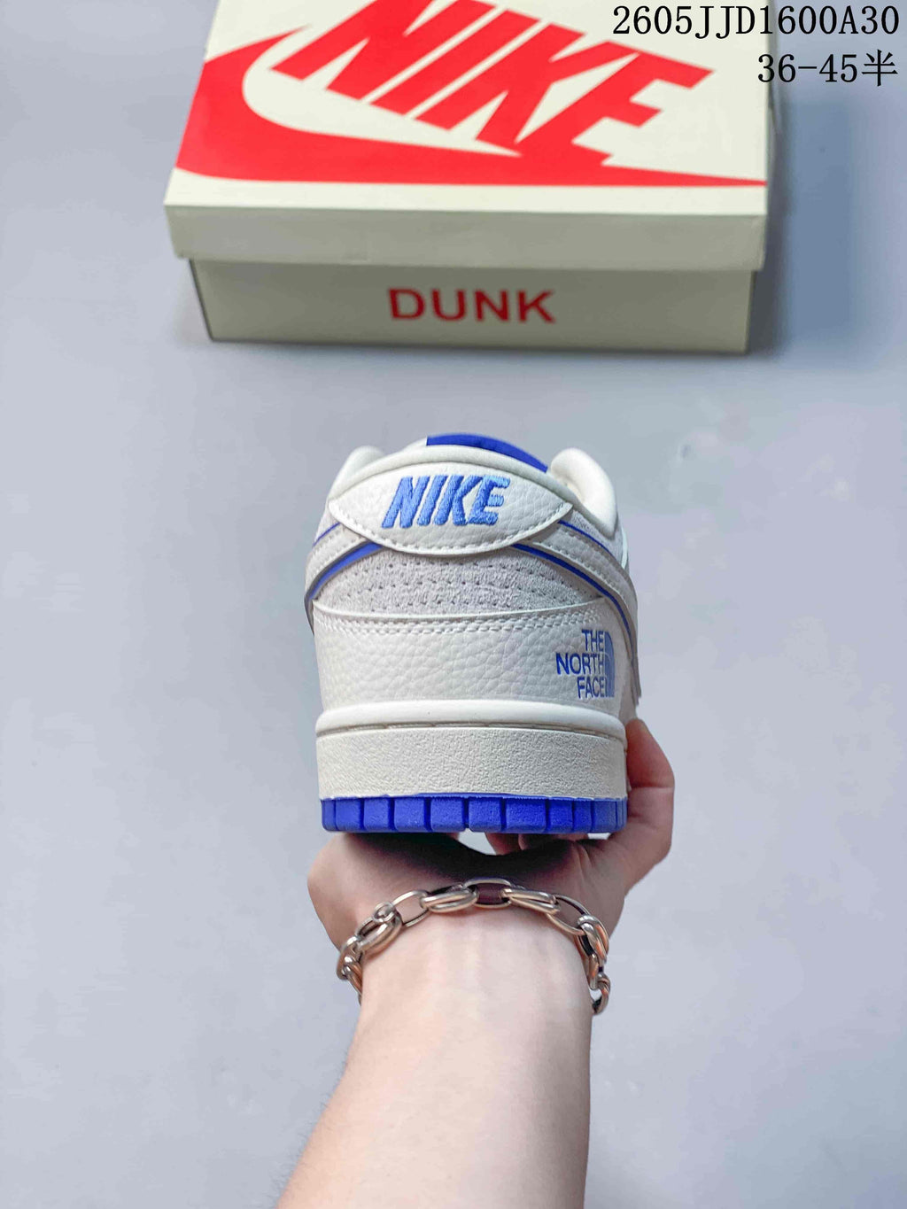 Heel view showing Nike and The North Face branding on a white and blue sneaker