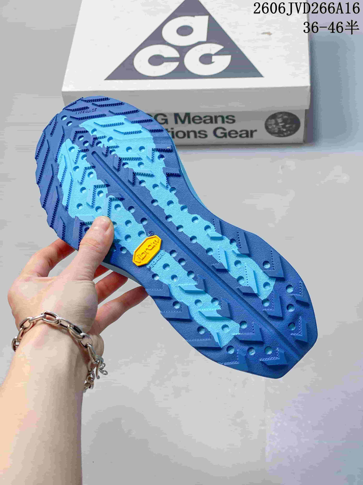 Close-up of the blue trail shoe outsole with lugged tread