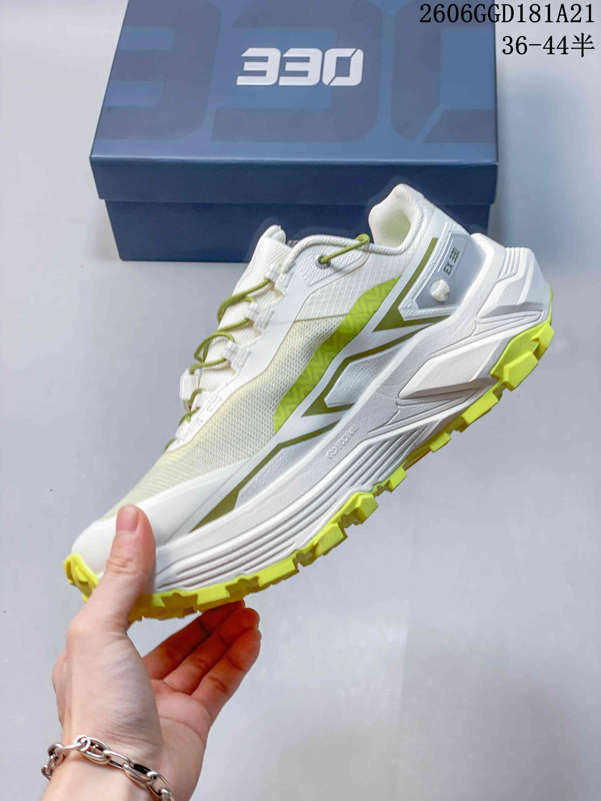 Side view of the white trail shoe with lime accents and sculpted sole