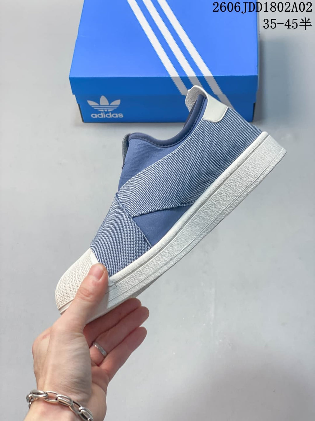 Side profile of the blue and white sneaker showing the low-top silhouette, layered upper panels, white heel tab, and white sole.