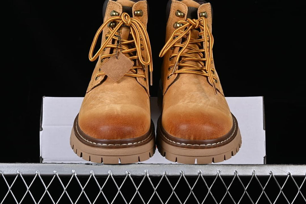 Front view of the pair of boots showing laces and lugged soles