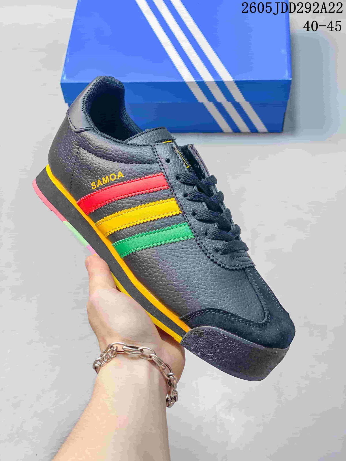 Dark gray Adidas Samoa low-top sneaker with red, yellow, and green side stripes