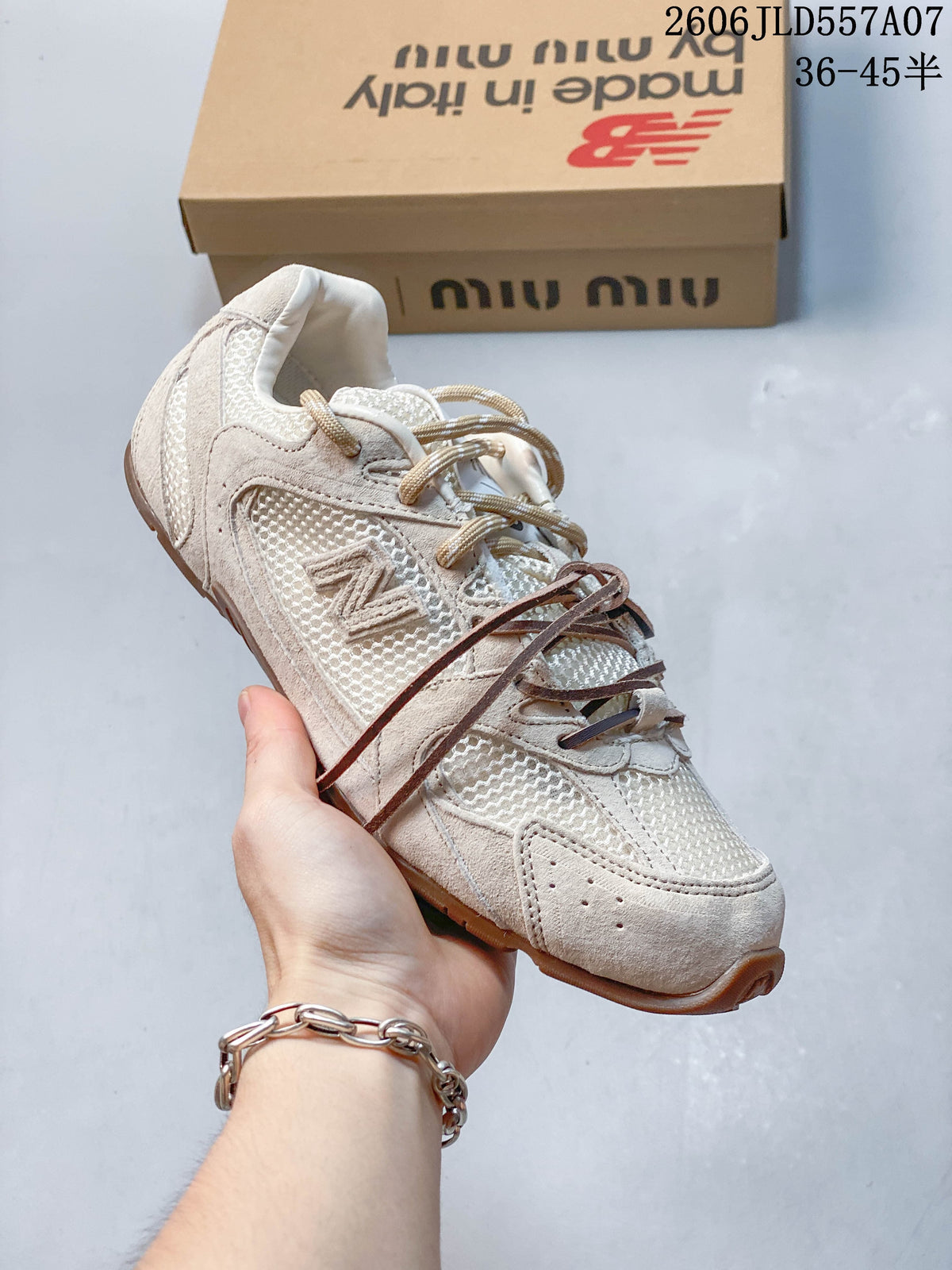 Angled view of the beige sneaker with contrasting decorative laces and a brown-toned outsole.