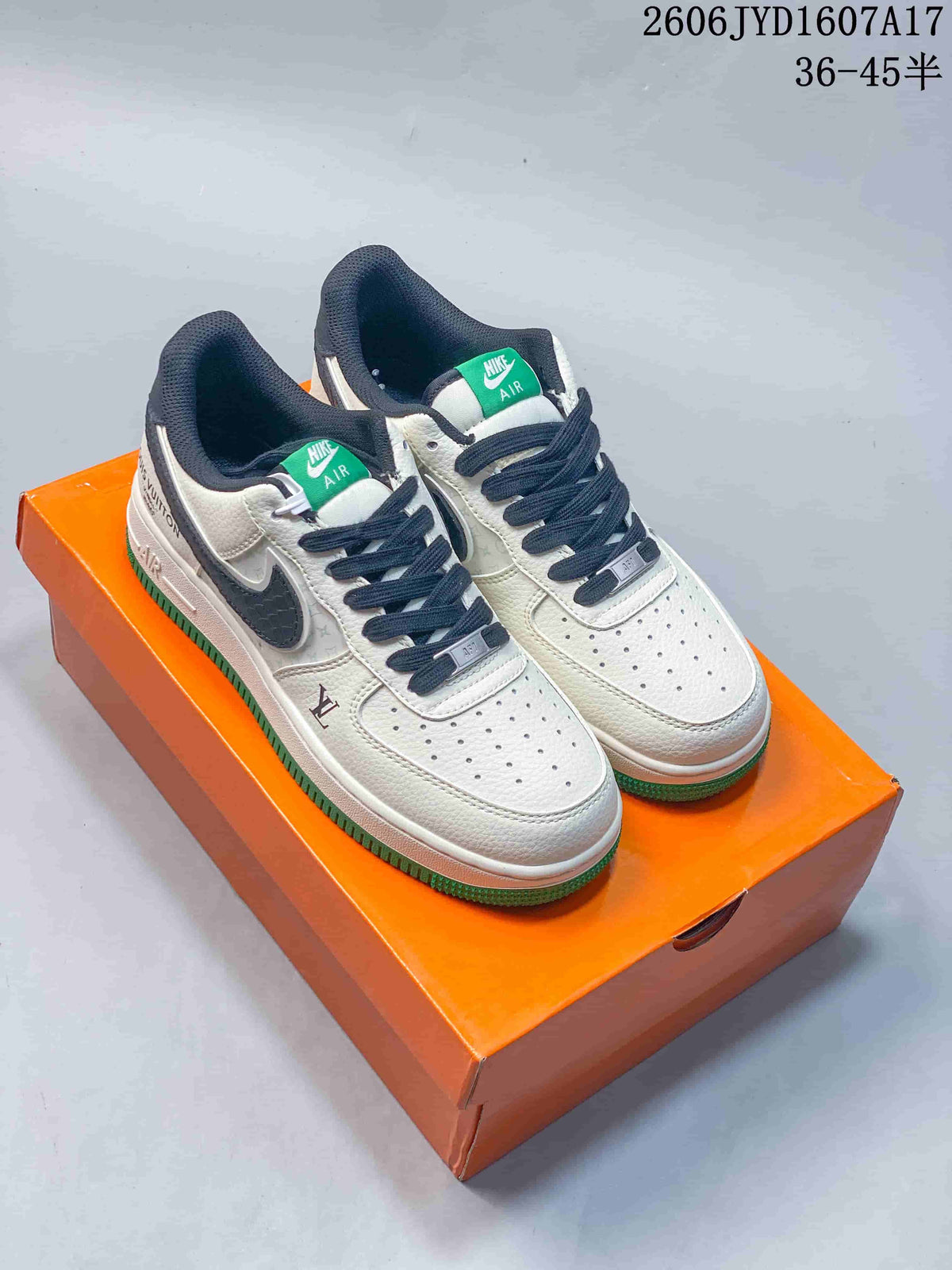 Pair of off-white low-top sneakers with dark laces and green outsole on an orange box