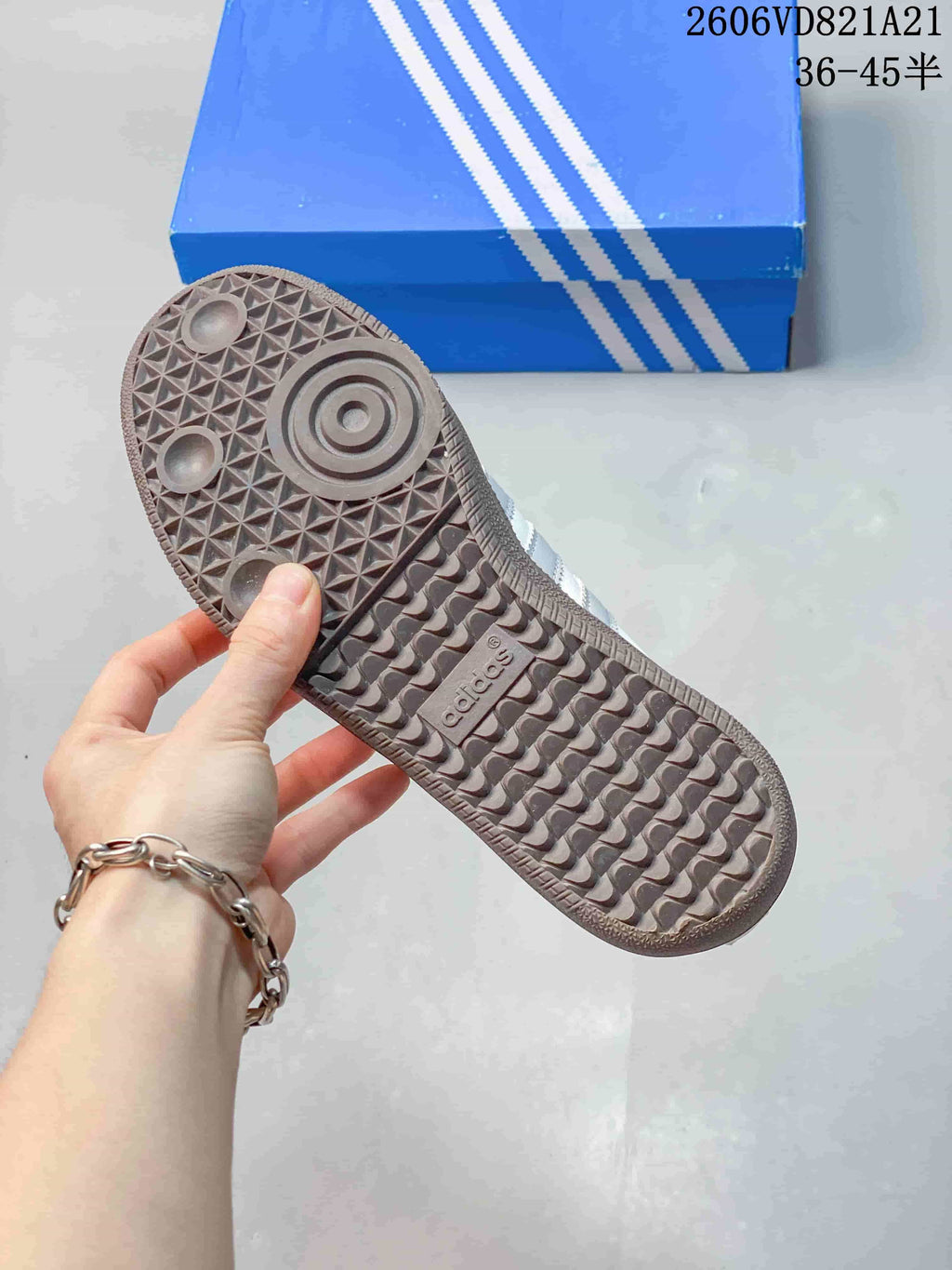 Underside of a sneaker showing a patterned gum-colored outsole