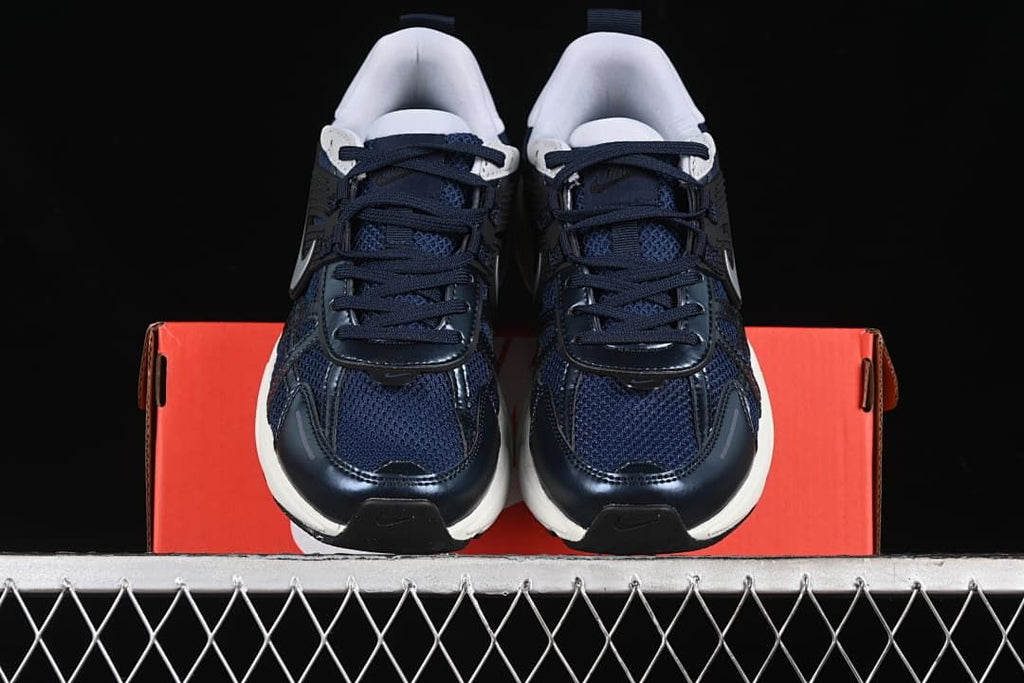 Front view of the pair showing navy laces and white padded collars