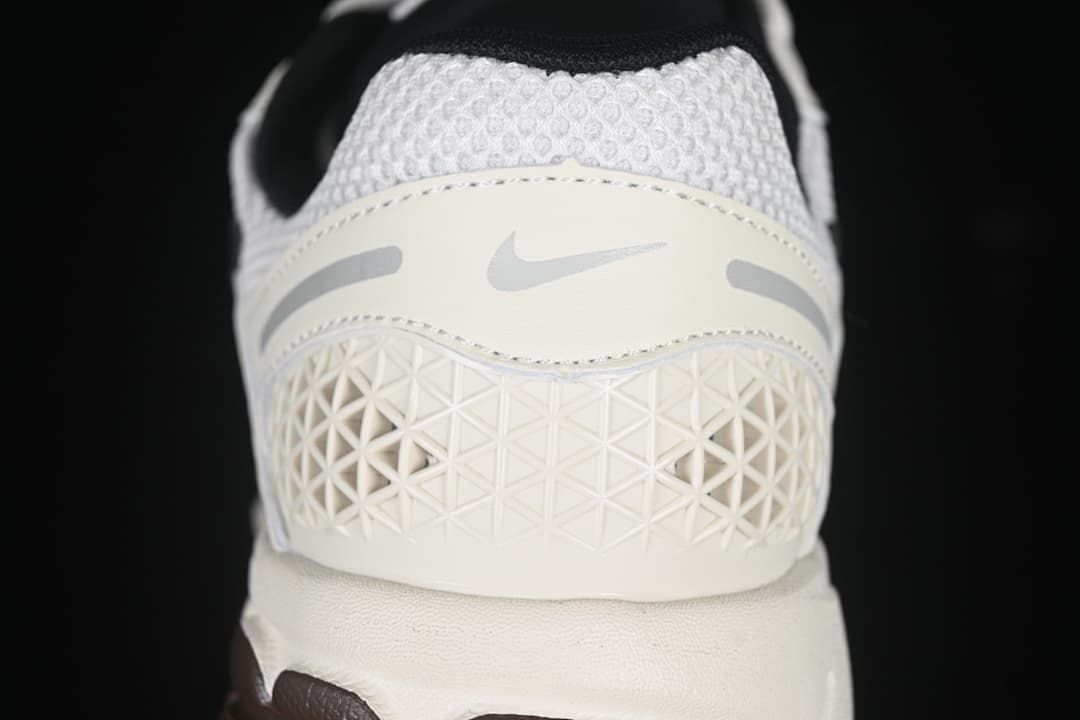 Rear view showing the mesh collar, geometric heel panel and outsole.