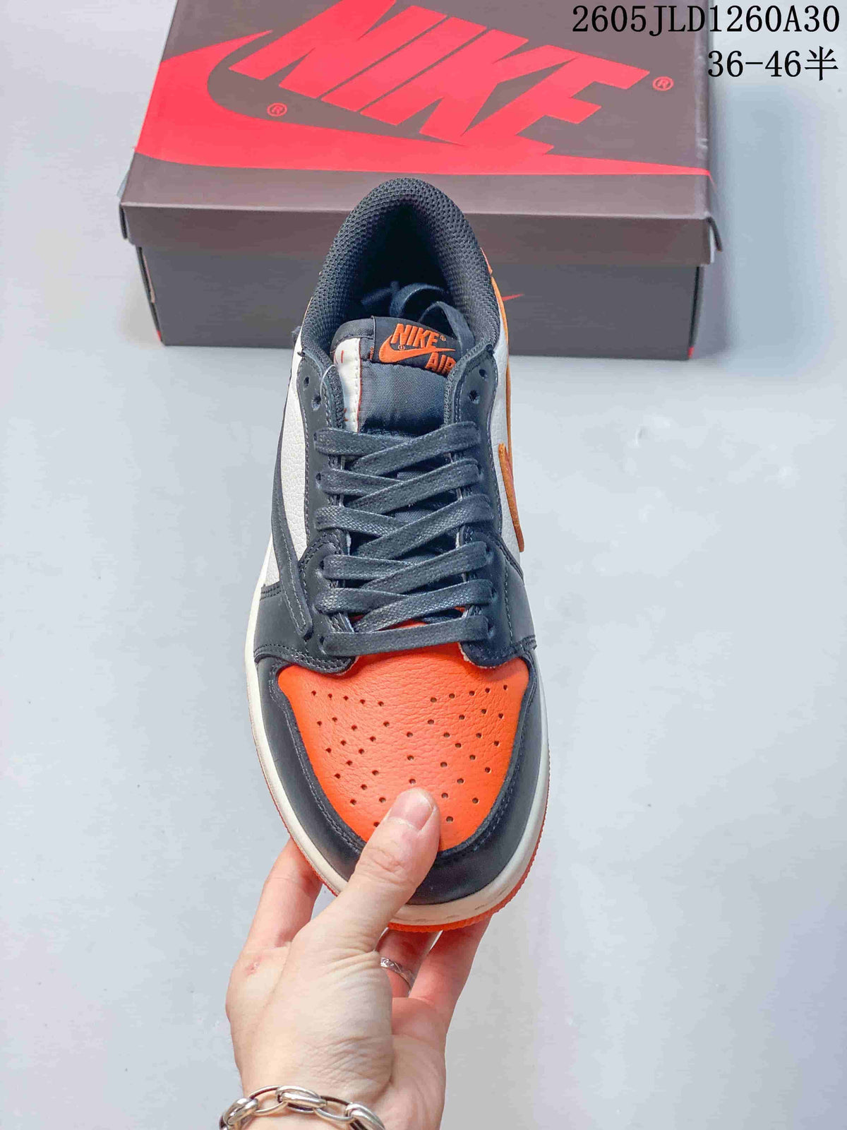 Top view of the orange perforated toe and charcoal laces