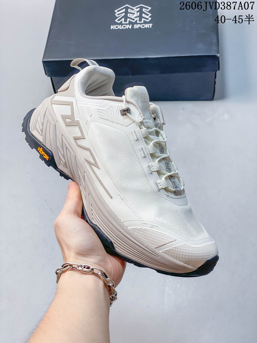 Angled side view of the off-white sneaker with dark outsole