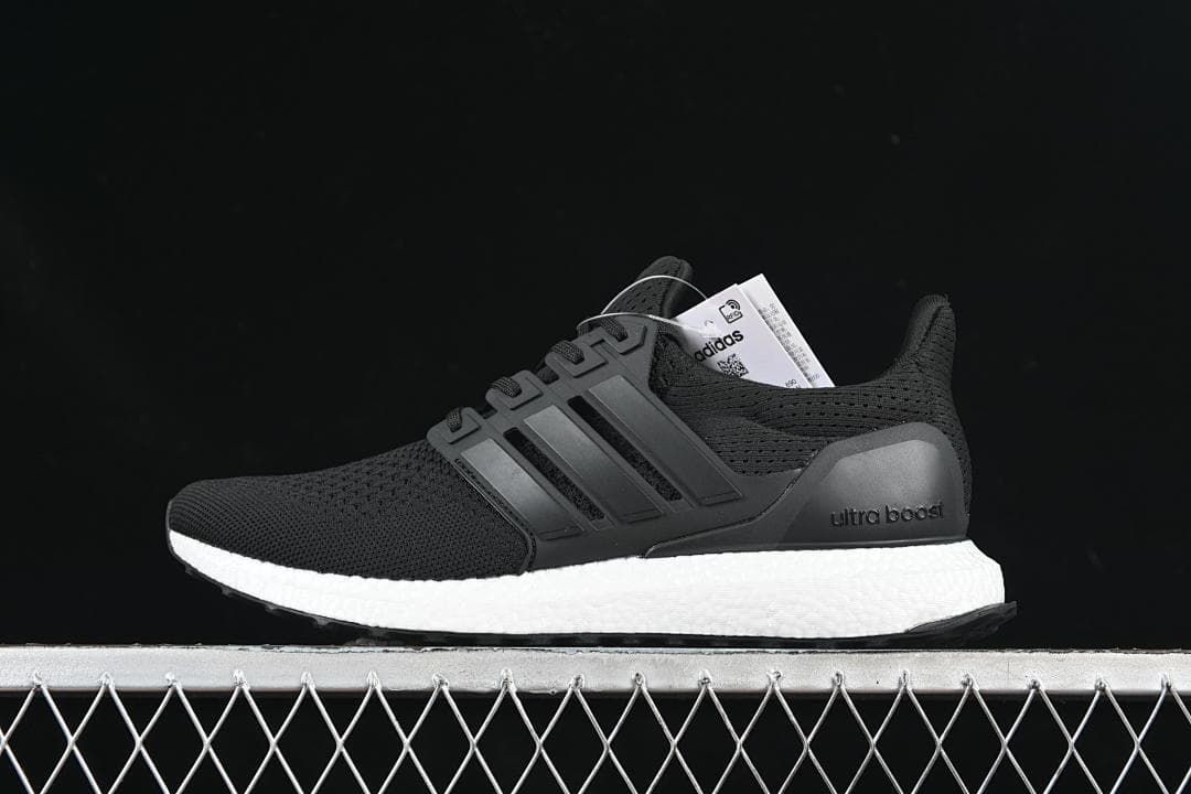 Side view of the shoe showing its knit upper, three stripes, and white midsole.