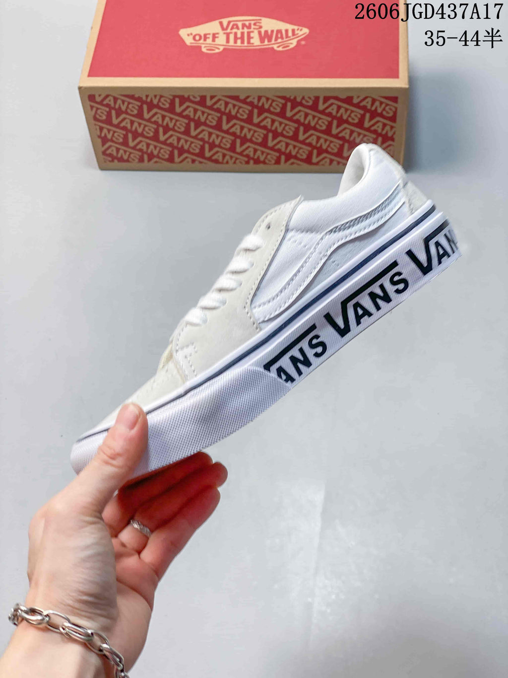Side view showing the sneaker’s side stripe and printed Vans sole lettering.