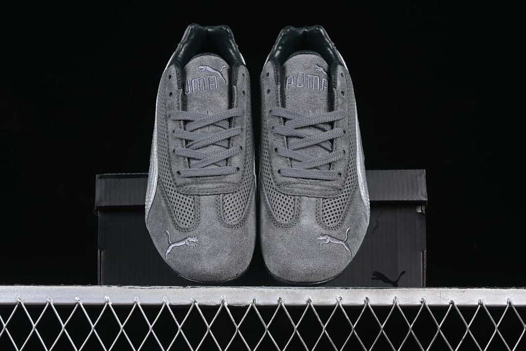 Front view of the pair of gray Puma sneakers