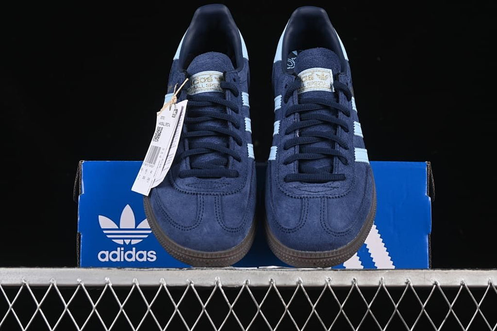 Front view of the pair displayed on an adidas box