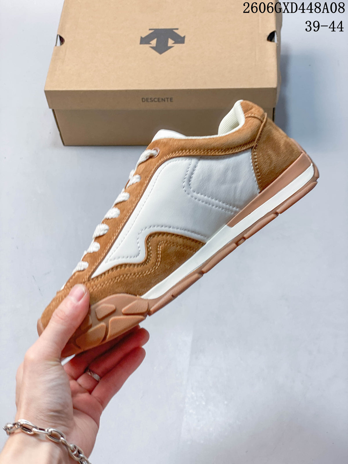 Side profile of the brown and white low-top sneaker