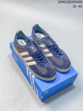 Navy adidas Gazelle Indoor sneakers with light stripes and a gum-colored outsole, pictured on a blue shoe box