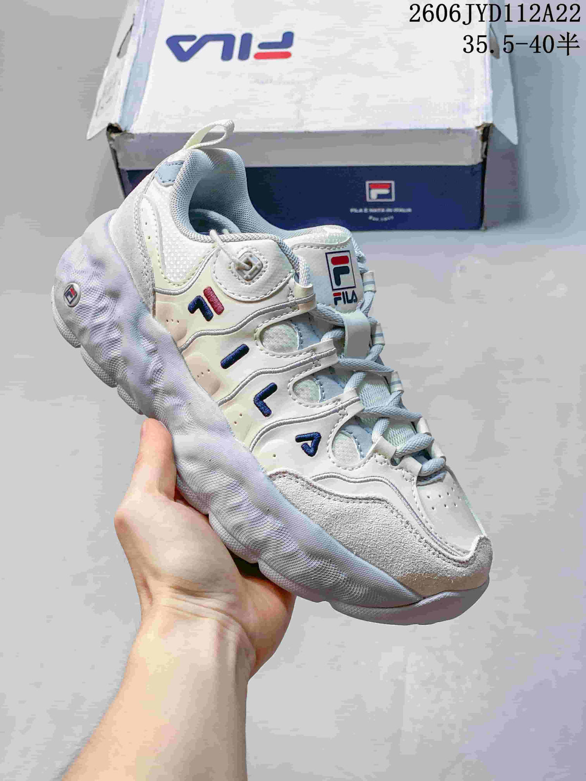 Angled view of a white and gray FILA Muffin sneaker