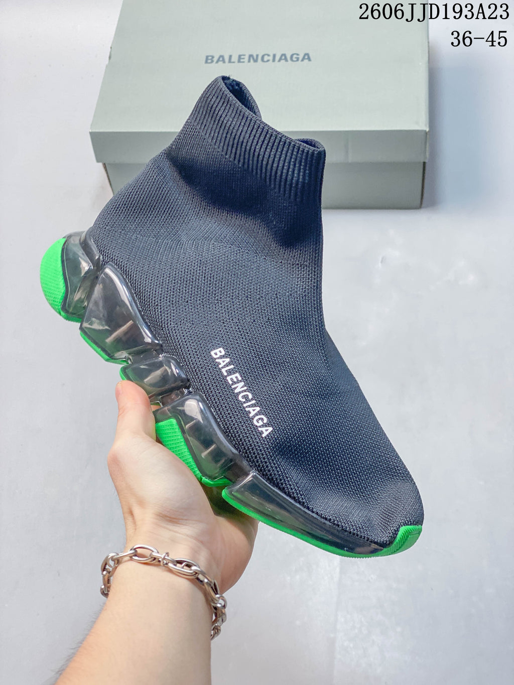 Navy sock-style sneaker with white Balenciaga lettering and neon-green sole accents