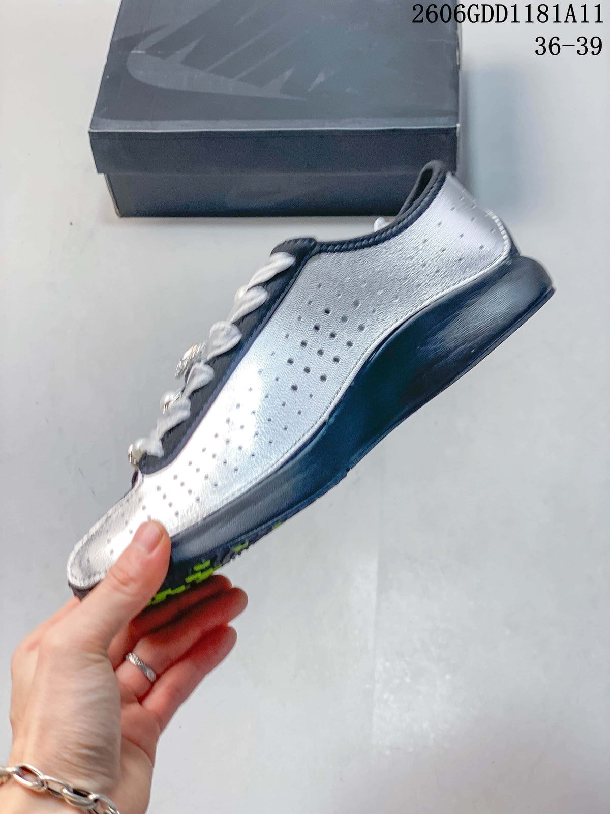 Side view showing the perforated silver panel and dark sole.