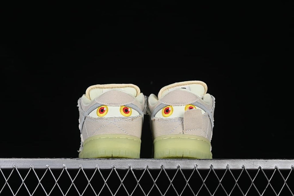 Rear view of both shoes showing embroidered eye graphics