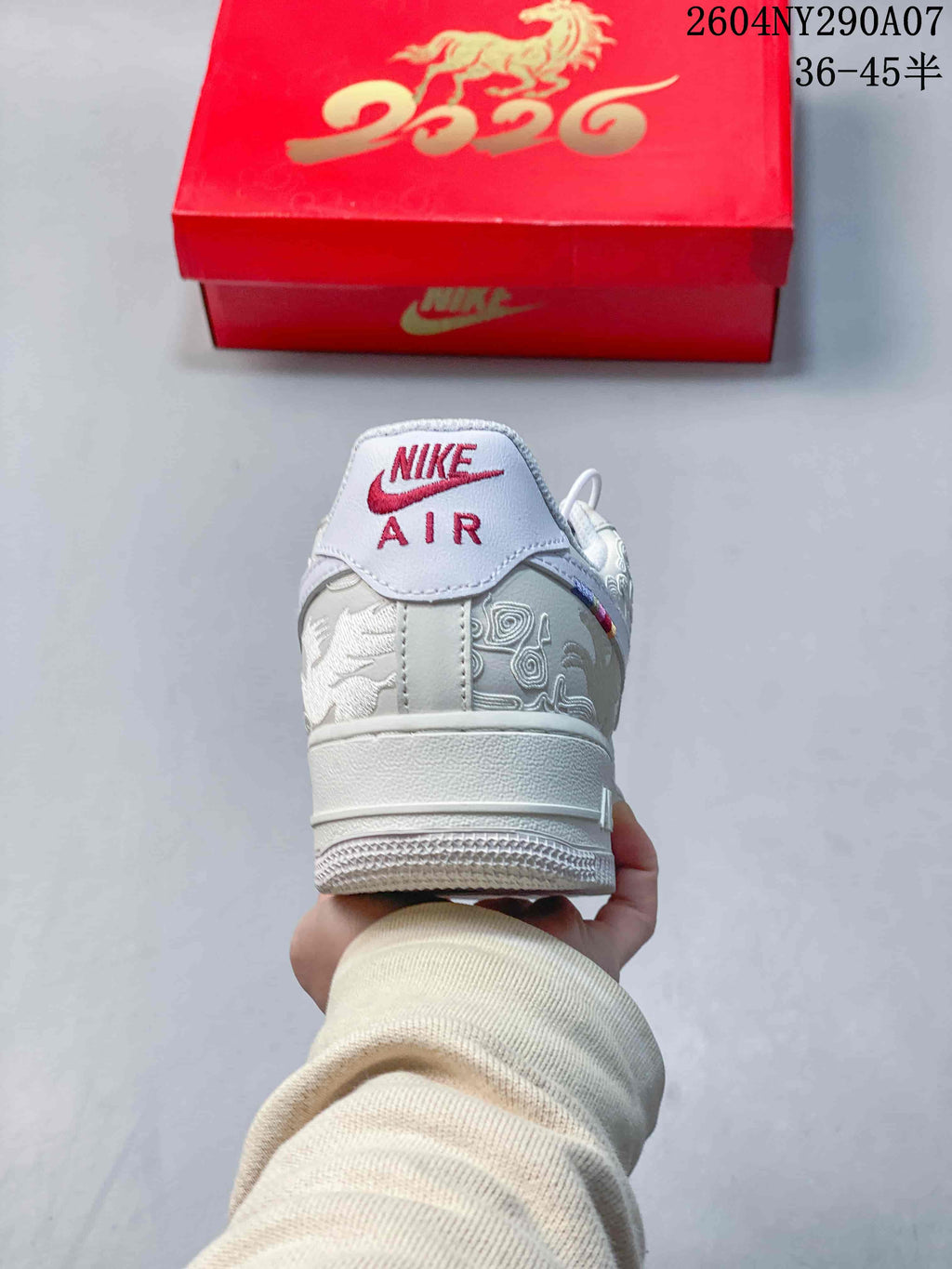 Heel view showing embroidered panels and Nike Air branding on a white sneaker