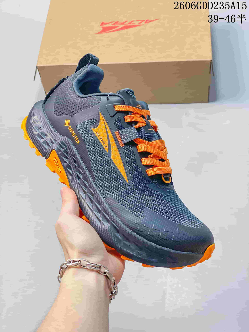 Angled side view showing the shoe's GTX marking and orange outsole accents.