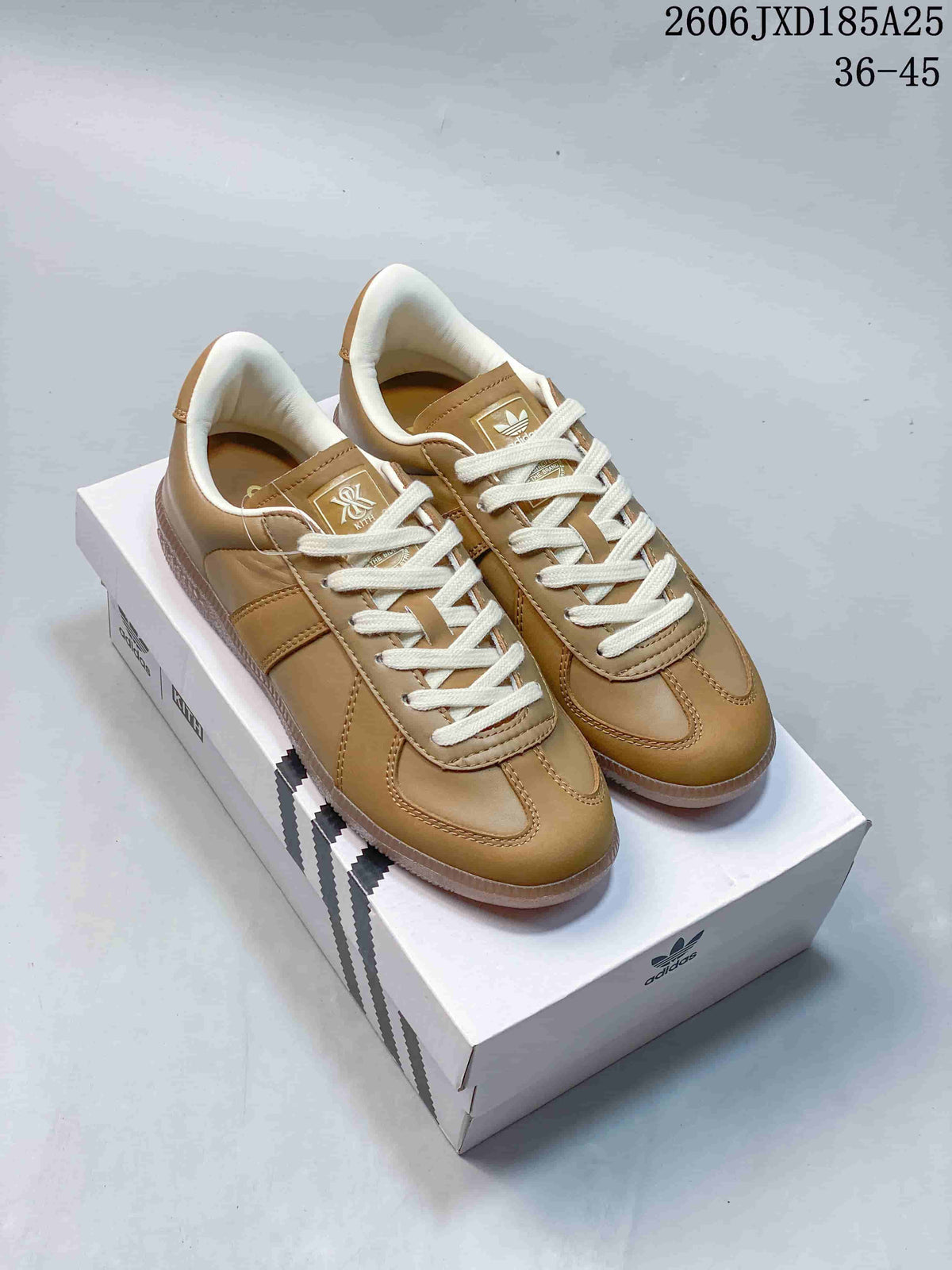Pair of tan adidas BW Army low-top sneakers with cream laces, shown on a shoebox.