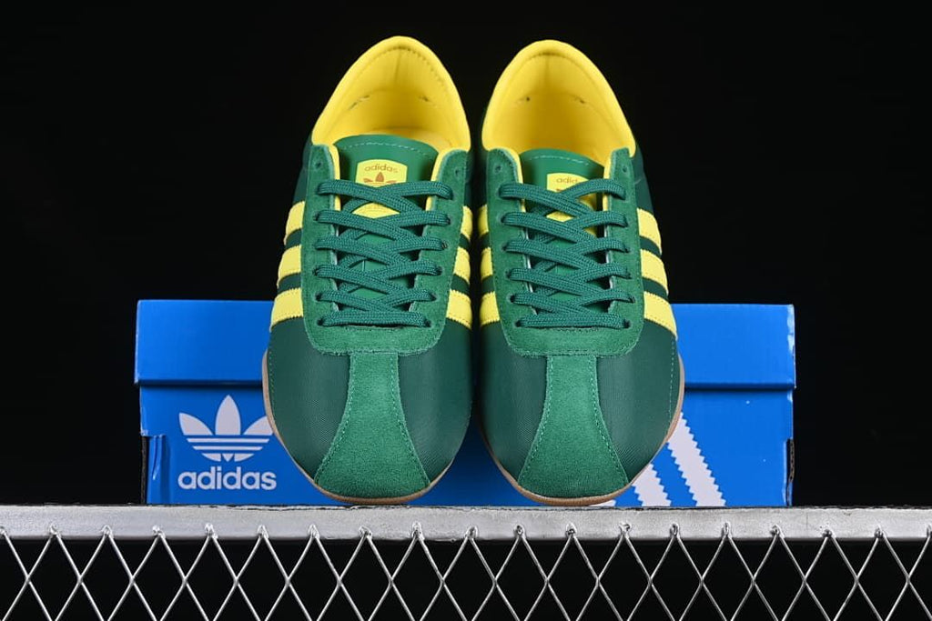 Front view of the pair showing green uppers, yellow lining and gum-colored soles