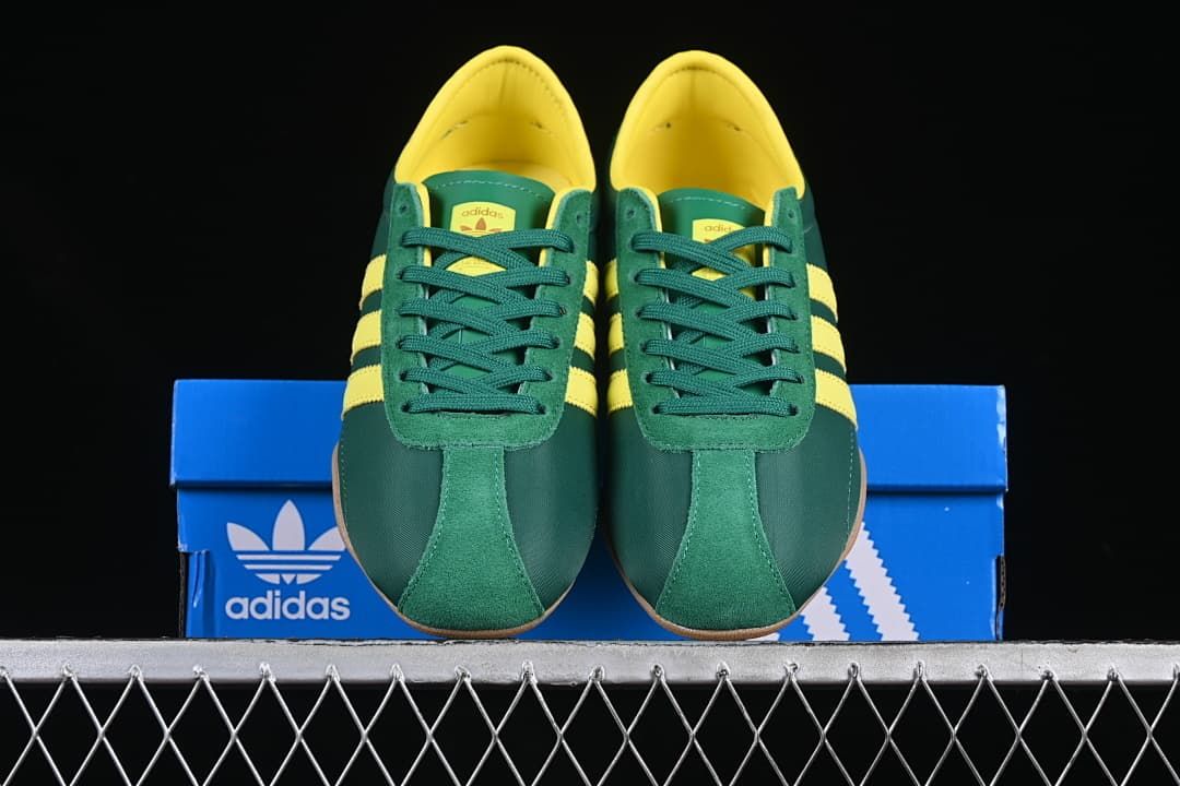 Front view of the pair showing green uppers, yellow lining and gum-colored soles