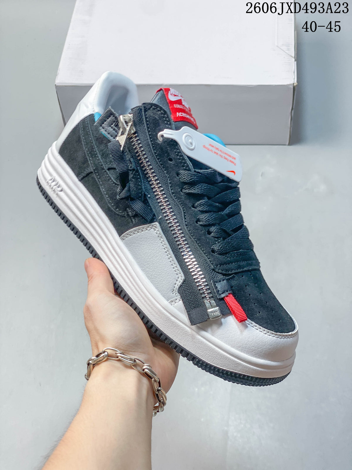 Close-up of a navy and white sneaker with a side zipper and contrasting accents