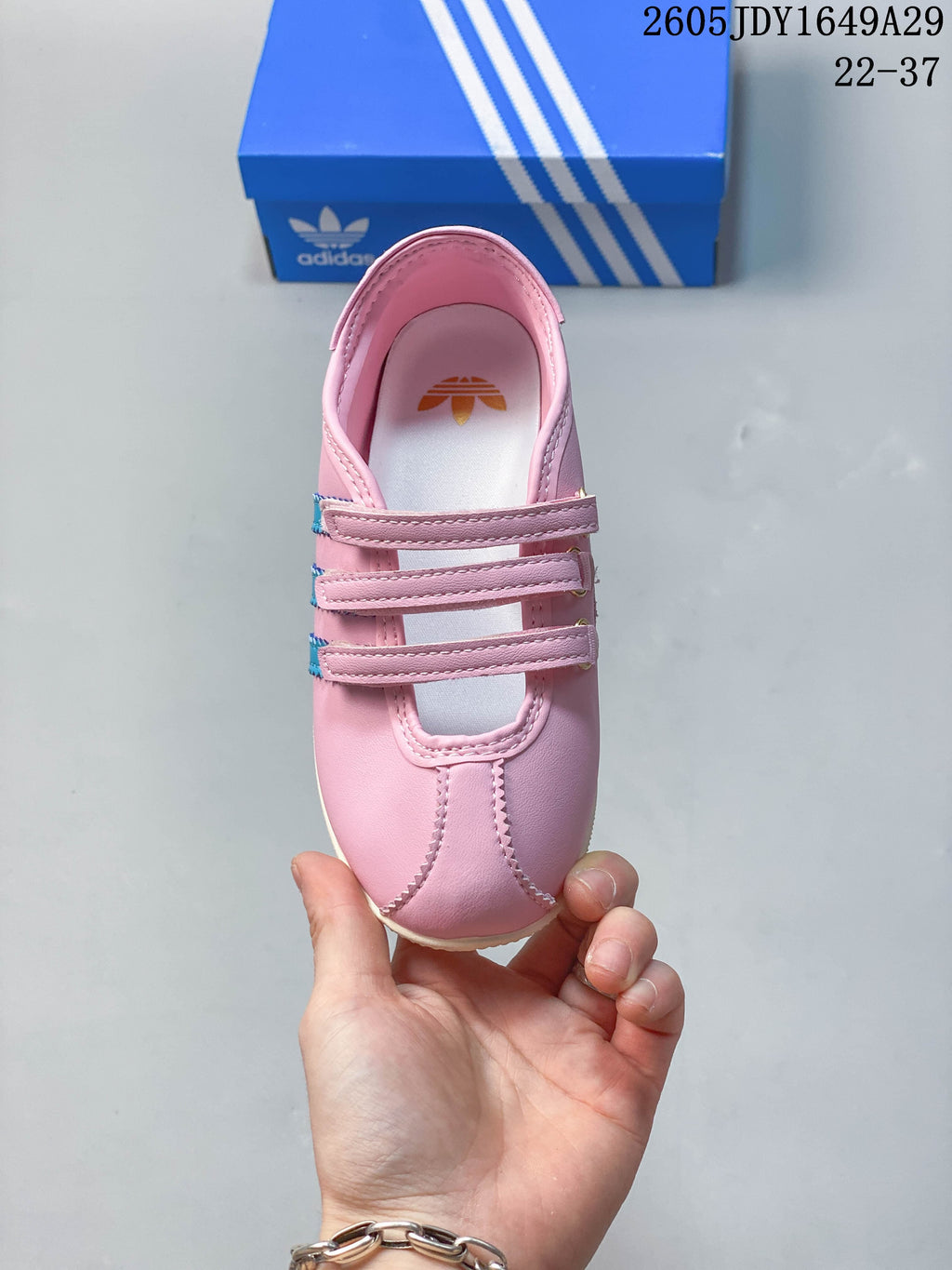 Top view highlighting the three hook-and-loop straps and pink upper.