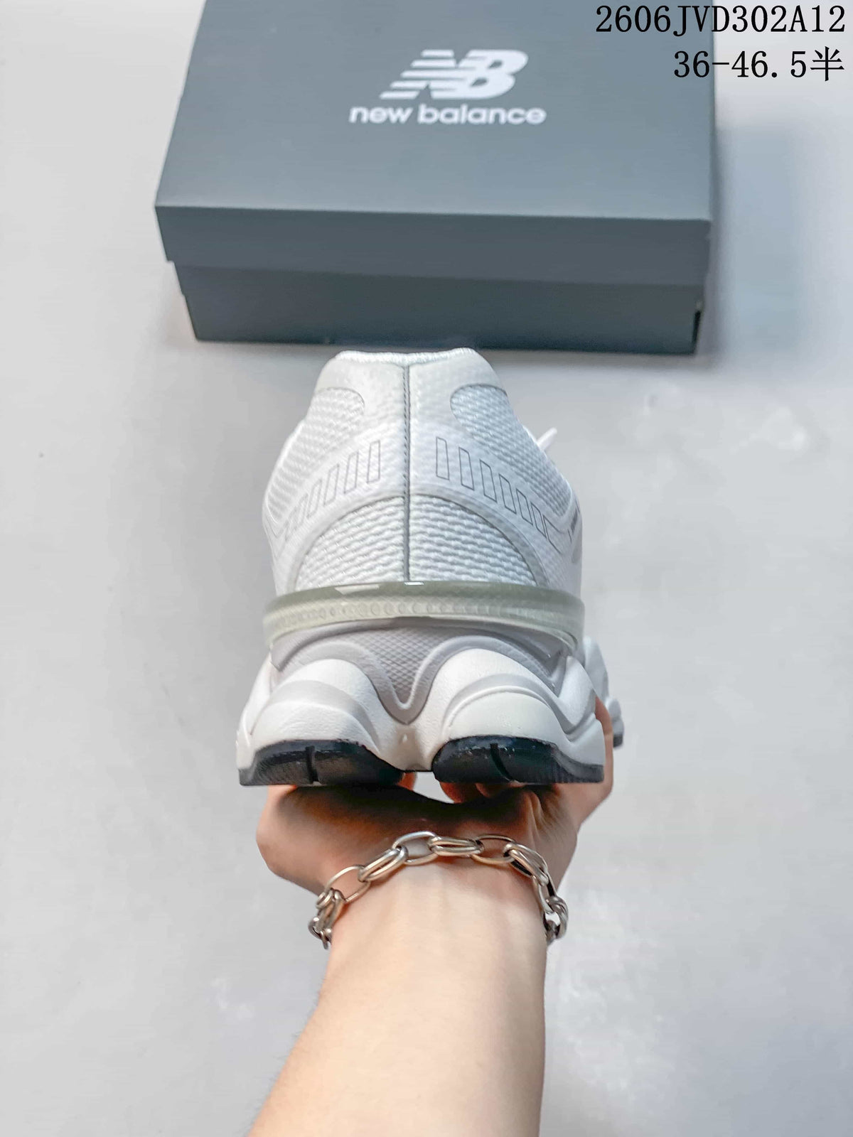 Rear view of the white sneaker showing the heel and sculpted sole.