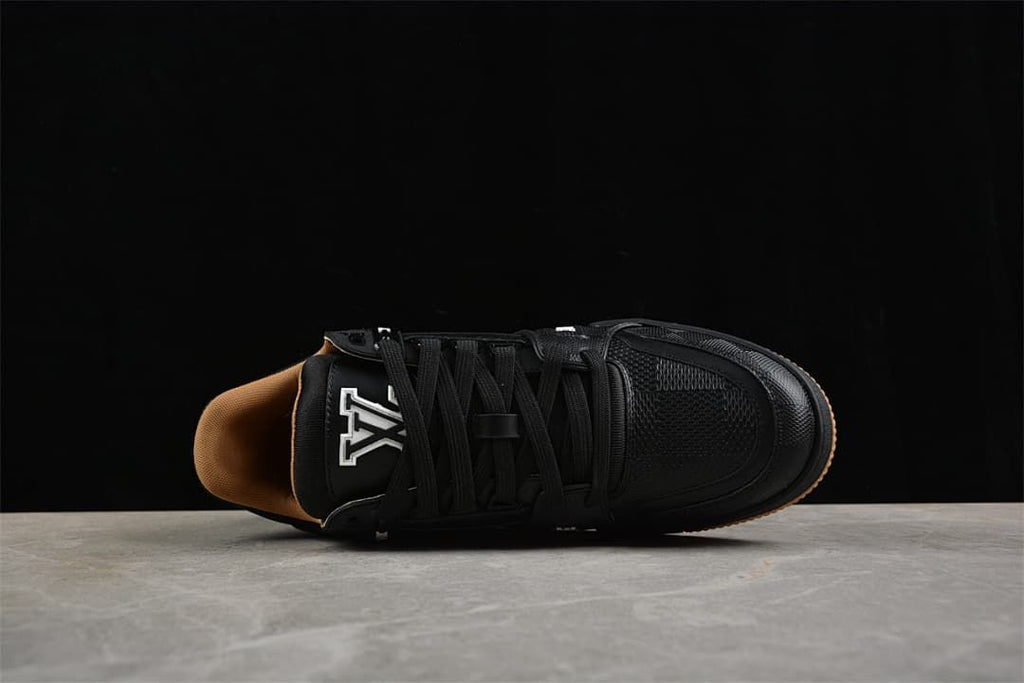Top view of a black lace-up sneaker with tan-colored lining