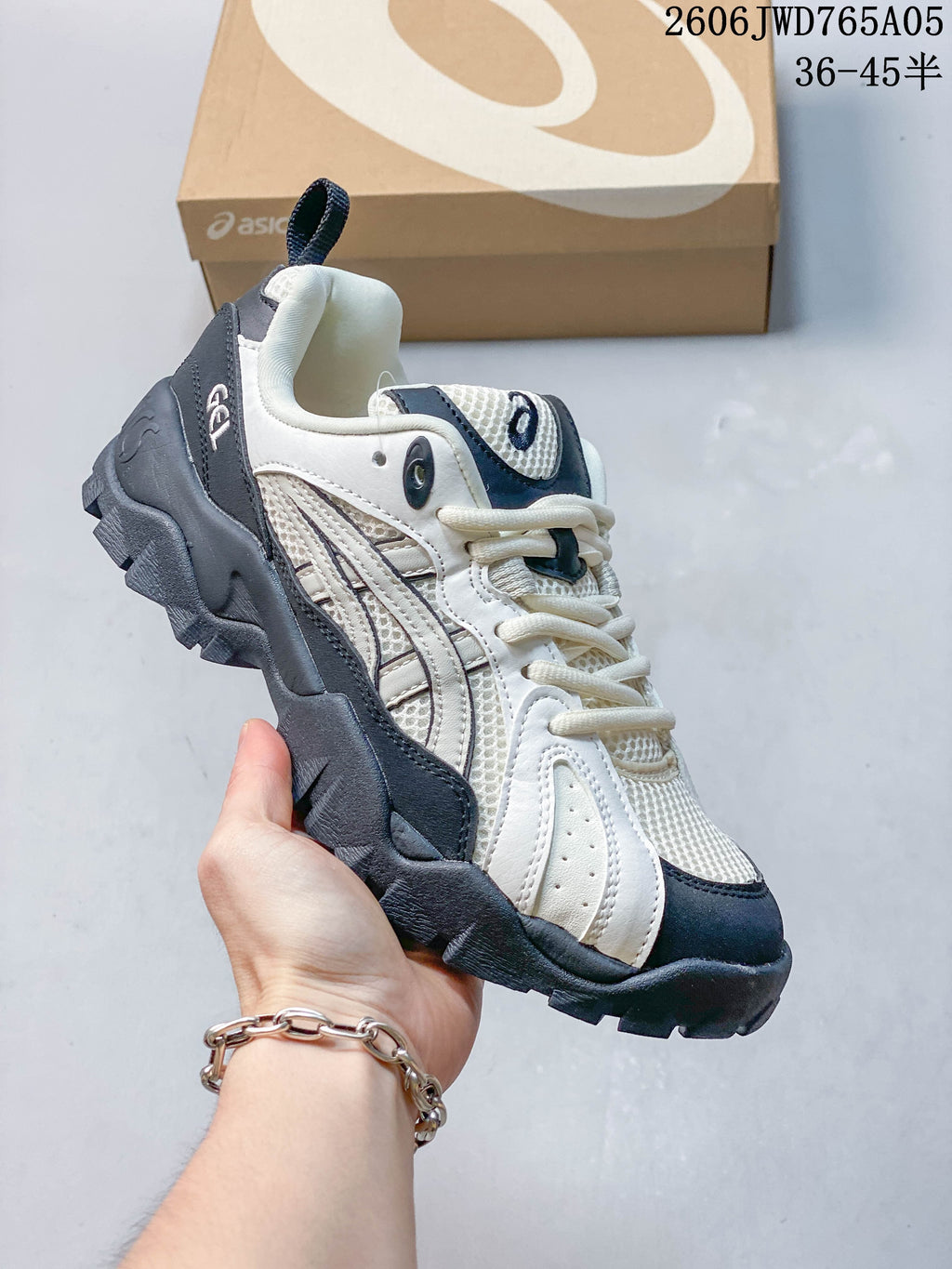 White and navy ASICS Gel-TRUCK sneaker with mesh-like panels and a chunky outsole.