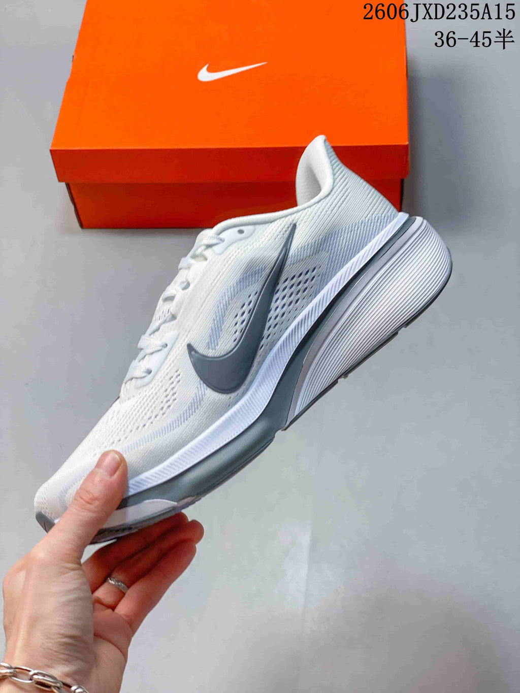 Side view of the white Nike Pegasus 42 running shoe with a grey Swoosh