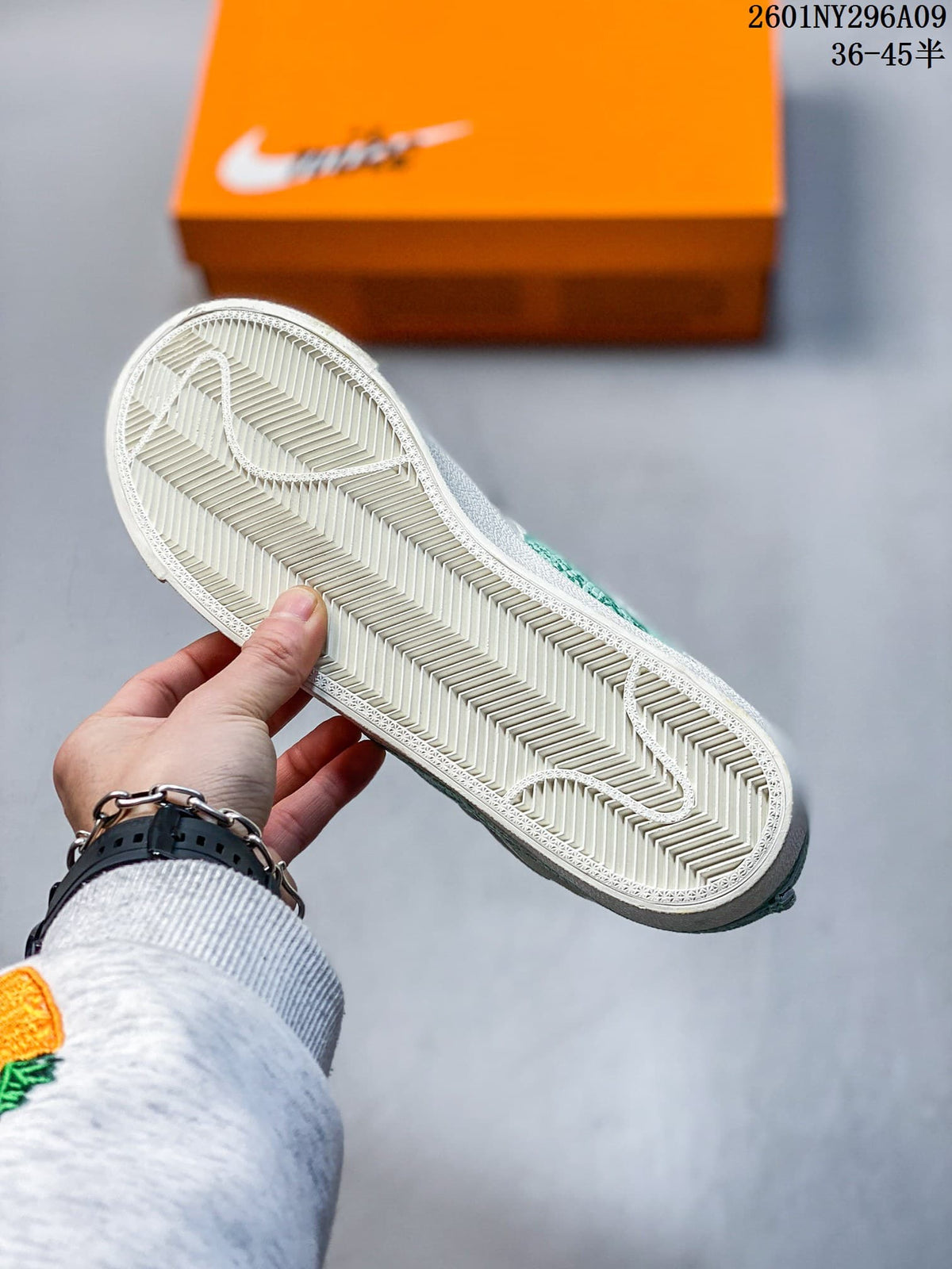 Underside of the white sneaker showing a patterned herringbone-style outsole.