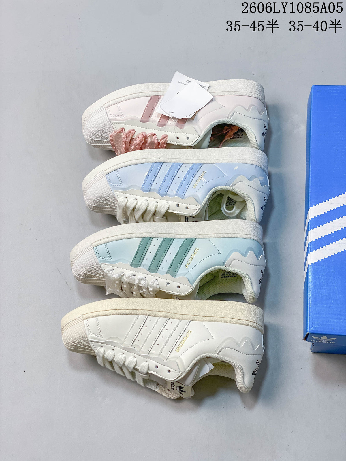 Four Superstar colorways shown from the side: blush pink, pale blue, mint, and cream