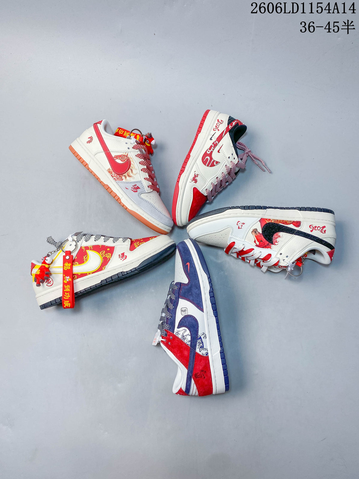 Overhead arrangement of five Nike SB Dunk Low colorways with zodiac-themed decorative graphics