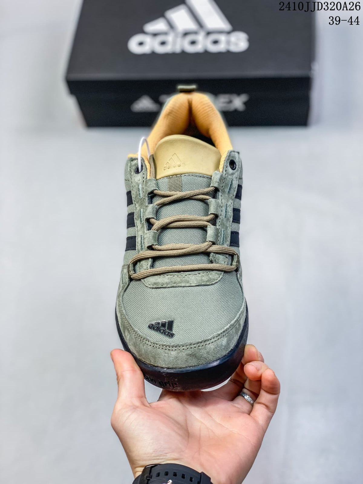 Front view of the lace-up green adidas Daroga shoe with tan lining.