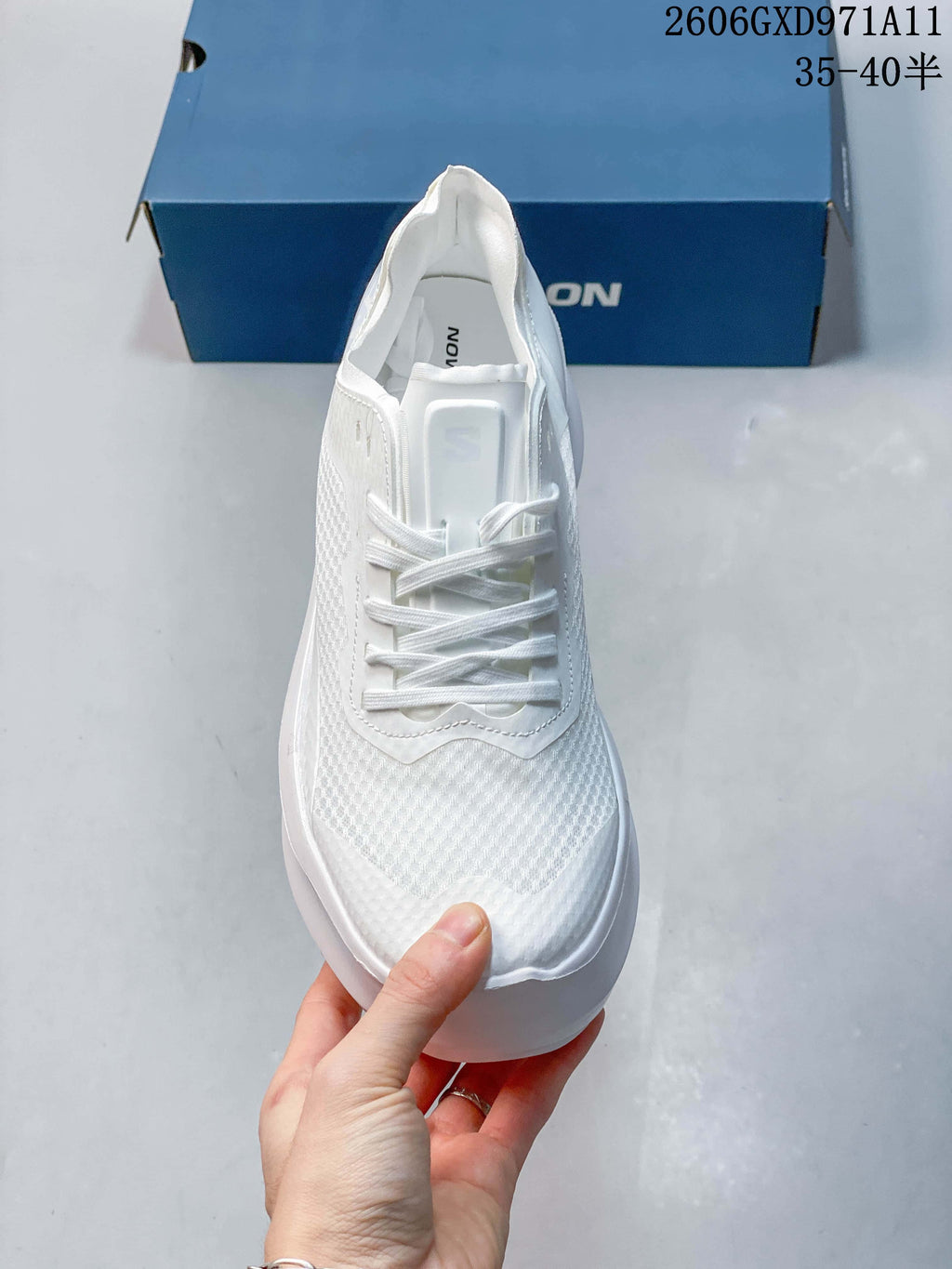Front view of a white lace-up sneaker