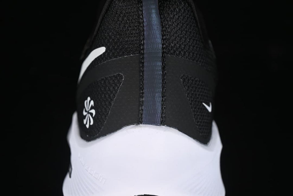 Rear view of the shoe showing heel details and white midsole