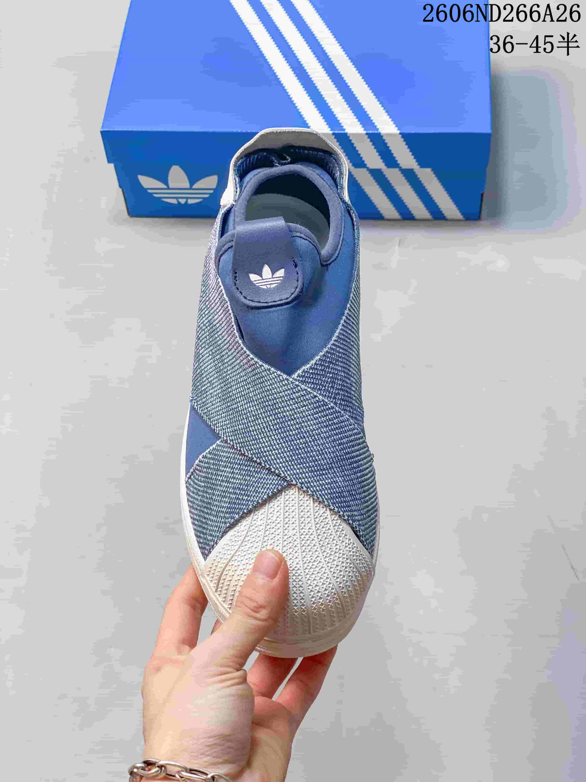 Top view of a blue slip-on sneaker with cross-over panels and a textured white toe cap.
