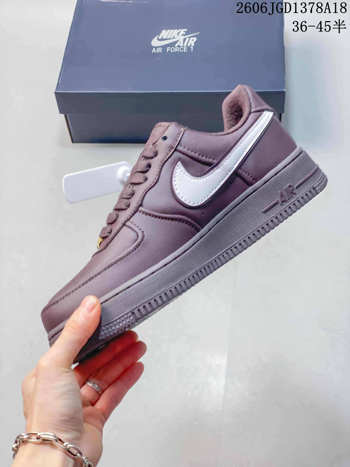Side profile of a mauve Air Force 1 sneaker with a white Swoosh and ridged outsole.