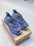 Pair of navy and purple ASICS NOVABLAST 5 running shoes displayed on a shoe box