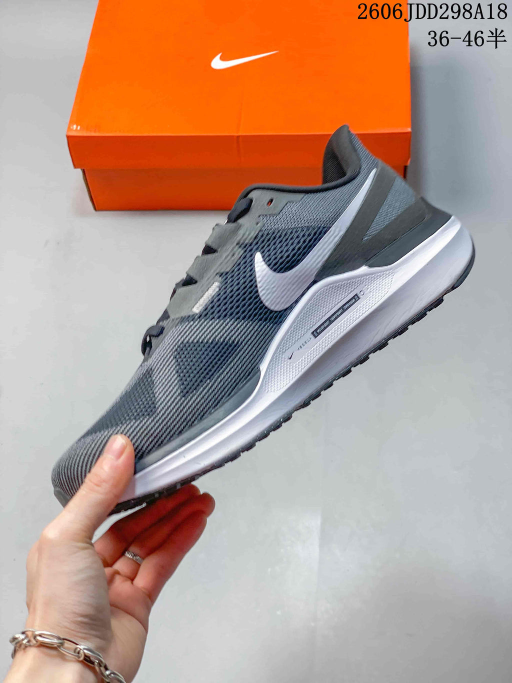 Side profile of the gray Nike Structure 25 running shoe