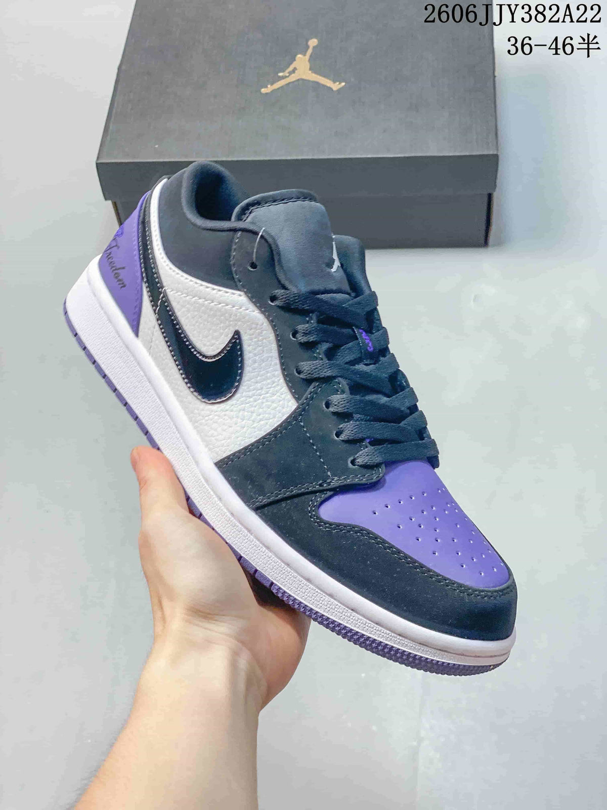Dark gray and white low-top sneaker with purple accents and a black Swoosh.