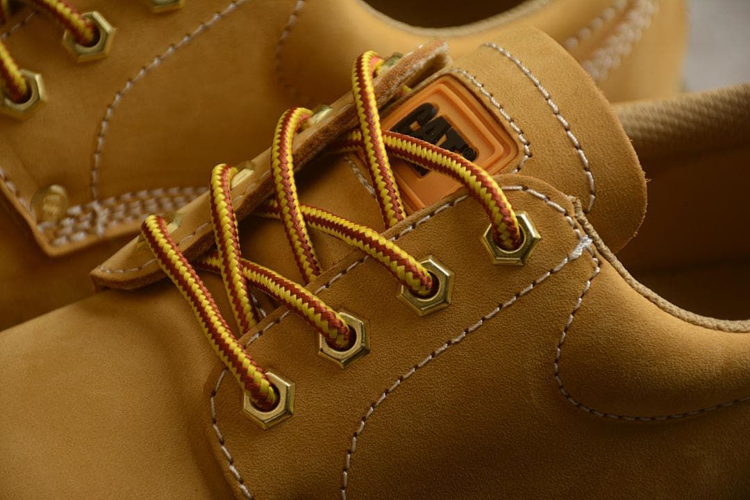 Detail of red-and-yellow laces threaded through metal eyelets